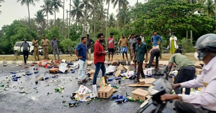 vehicle-carrying-liquor-topples-on-madurai-highway-commuters-loot-bottles