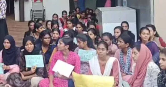 Students are staging a sit-in at Mansoor Hospital demanding the dismissal of the warden