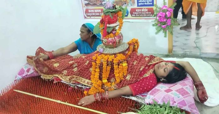 An extremely rare Navratri ritual: A 35-year-old homemaker in Bihar prays while lying on 2,516 sharp nails.